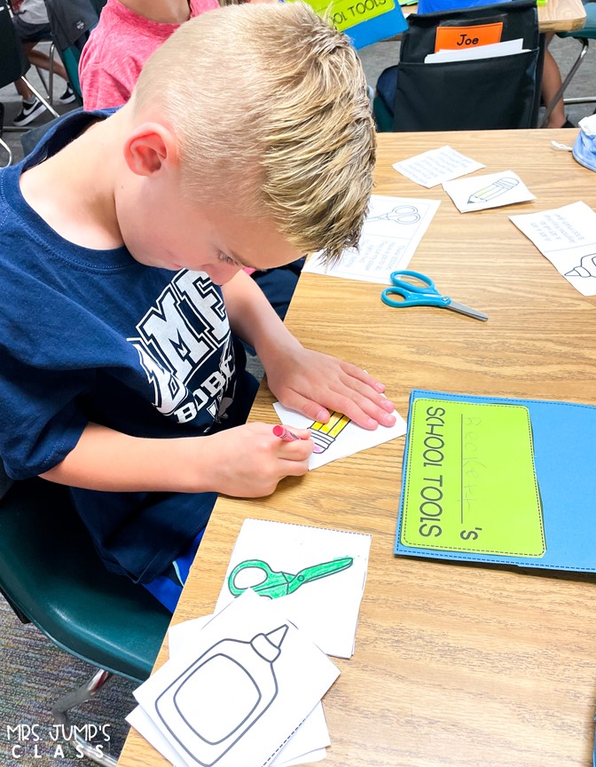 A young boy colors a picture of a pencil