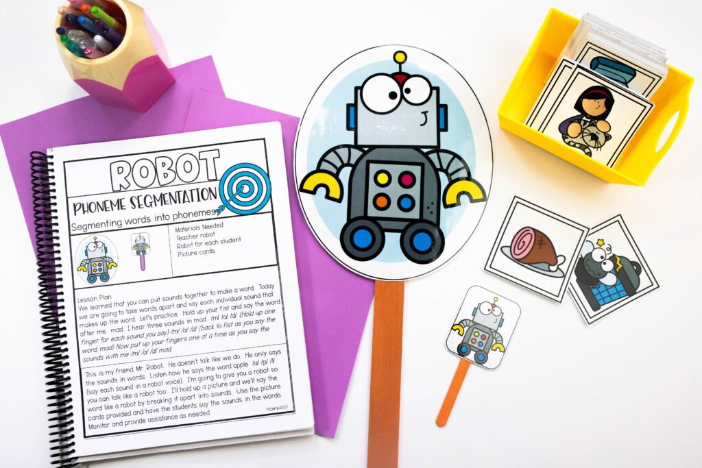 Robot visual on a popsicle stick, along with picture cards and a lesson plan