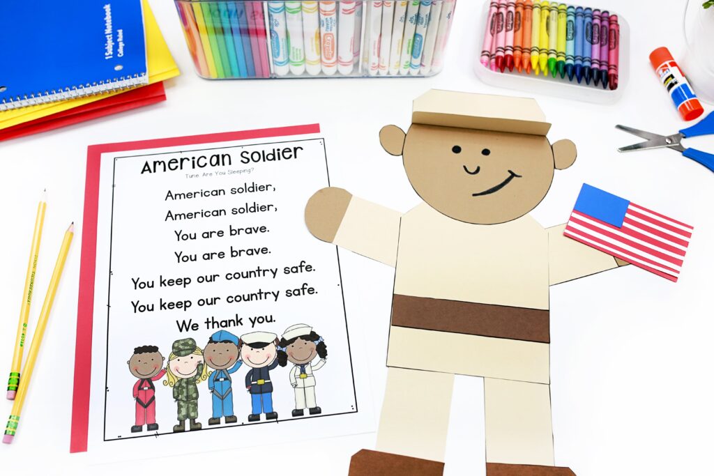 A paper craft of a military service member holding an American flag, along with the text of a Veterans Day song