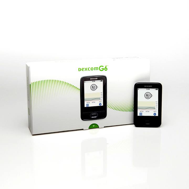 Зчитувач Dexcom G6 з дисплеєм і приймач у білому пакуванні.
