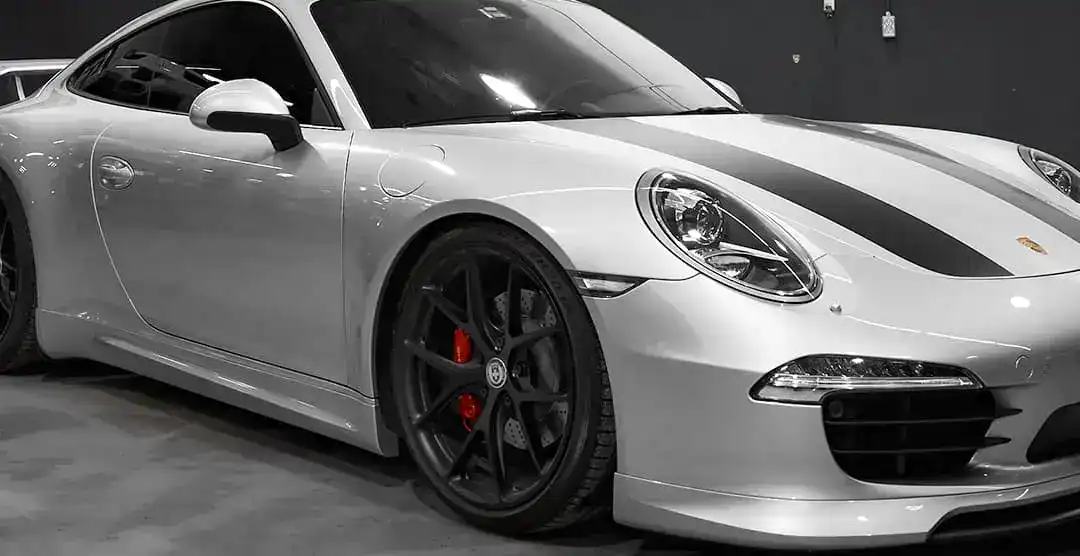 European Automotive Porsche 911 Carrera S in white with black accents.