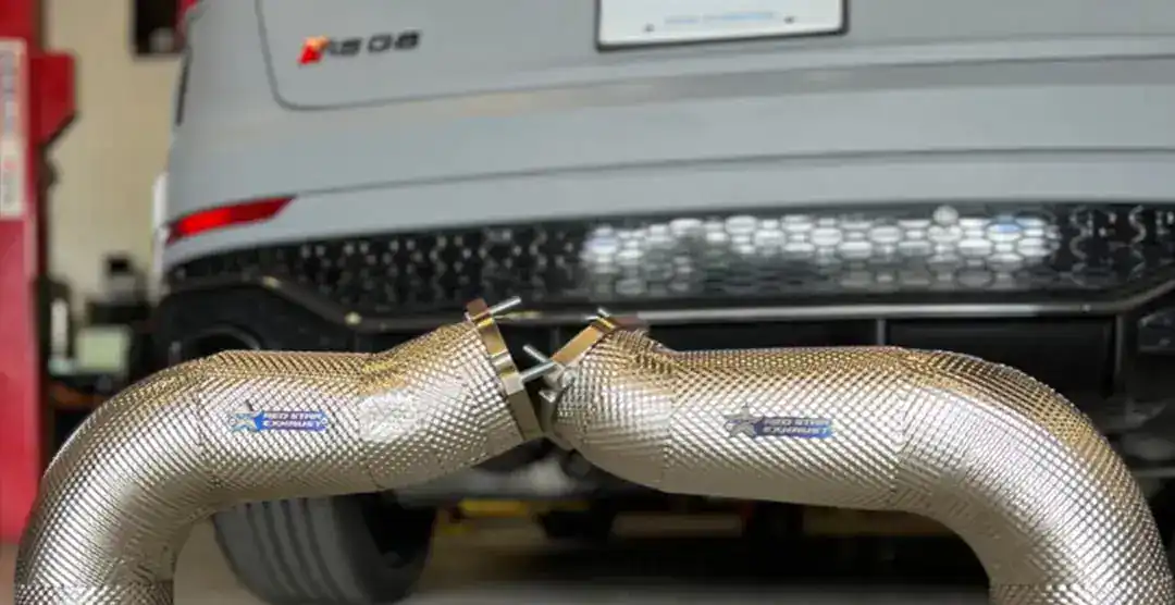 Close-up of RSQ8 exhaust pipes with European automotive branding.
