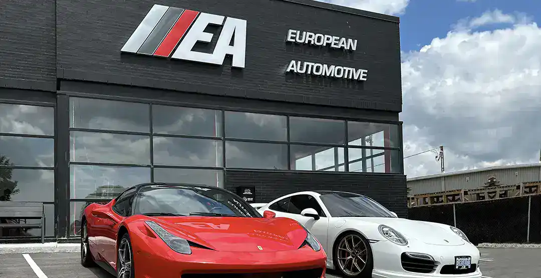 European Automotive dealership with two sports cars in front.