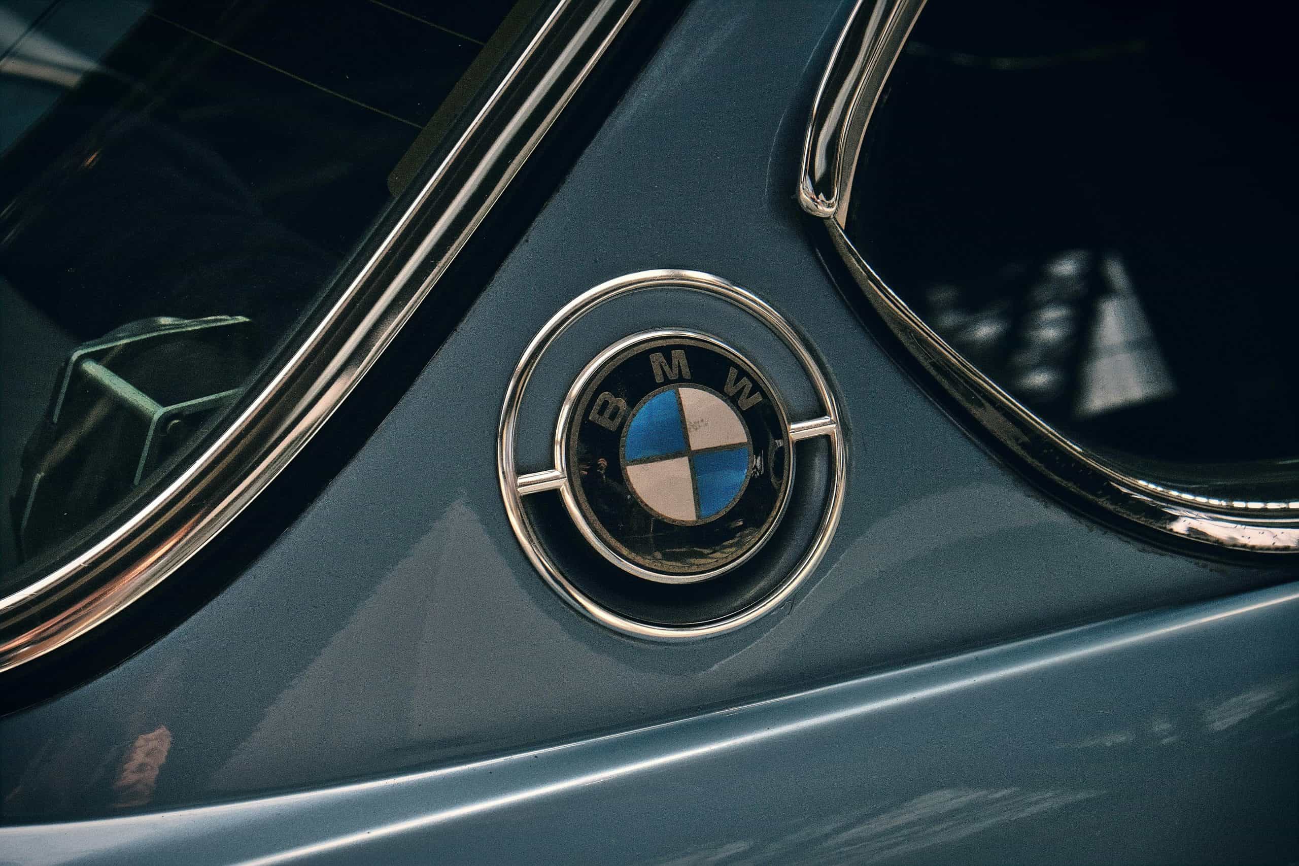 Close-up of BMW emblem on a vintage vehicle.