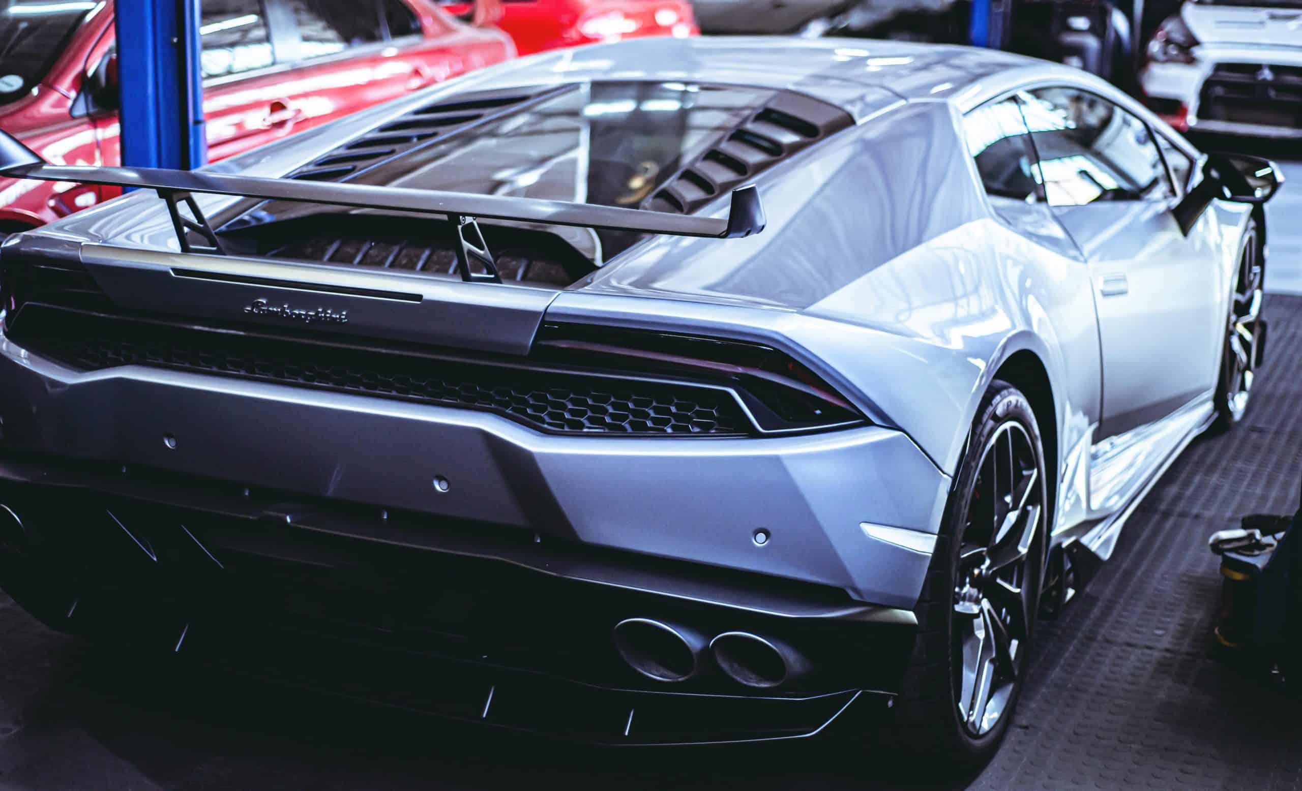 Silver Lamborghini Huracan sports car in a showroom.