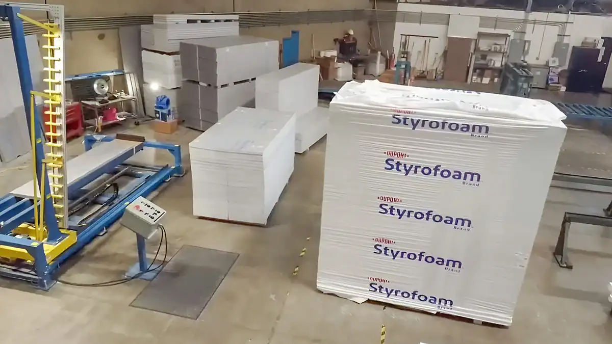 Industrial foam manufacturing process with stacked foam blocks.