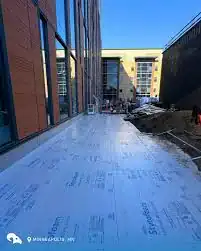 Inverted roof membrane being installed on a building rooftop.