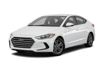 Modern white Hyundai sedan at HeVtech auto repair shop.