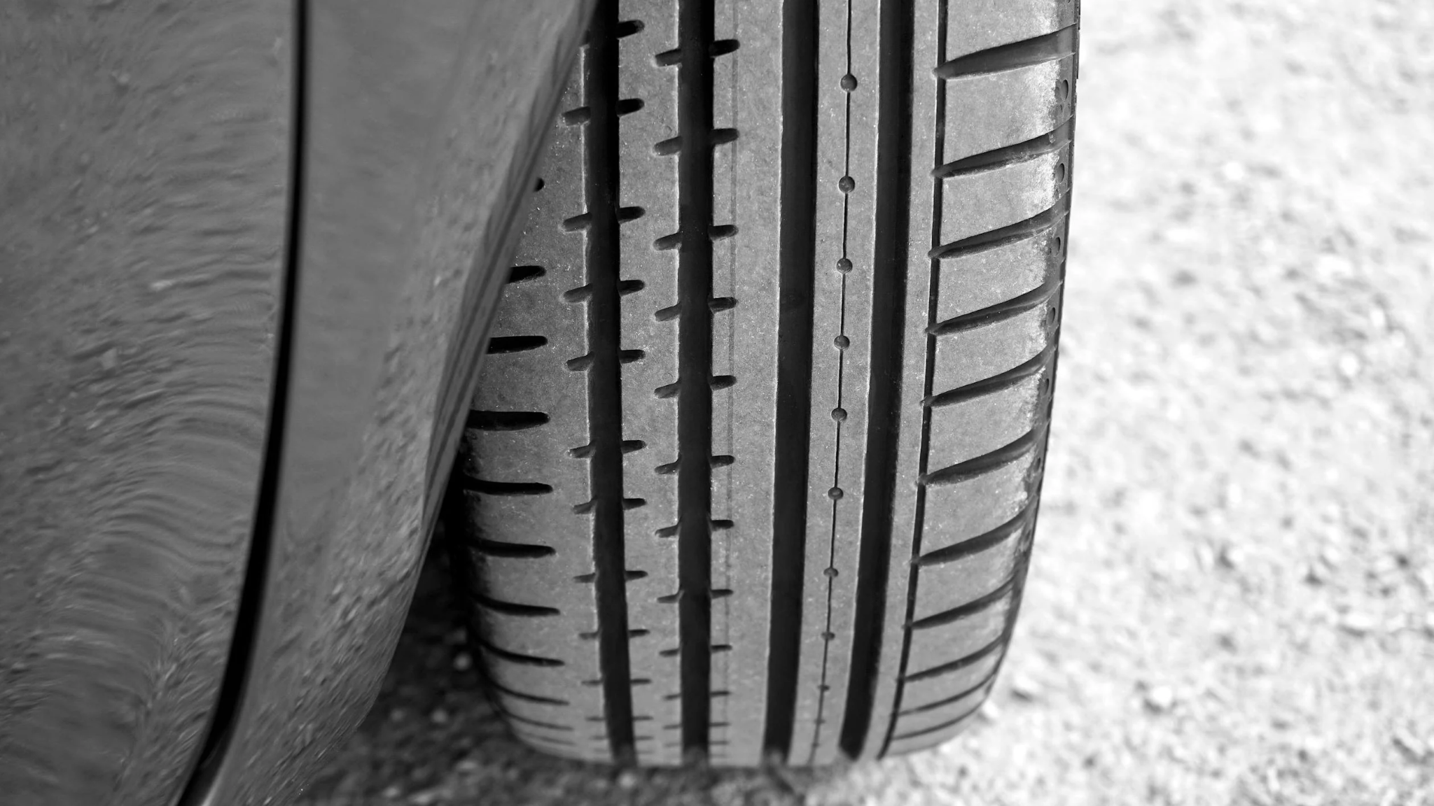Close-up of a car tire showing tread pattern and alignment for vehicle maintenance.