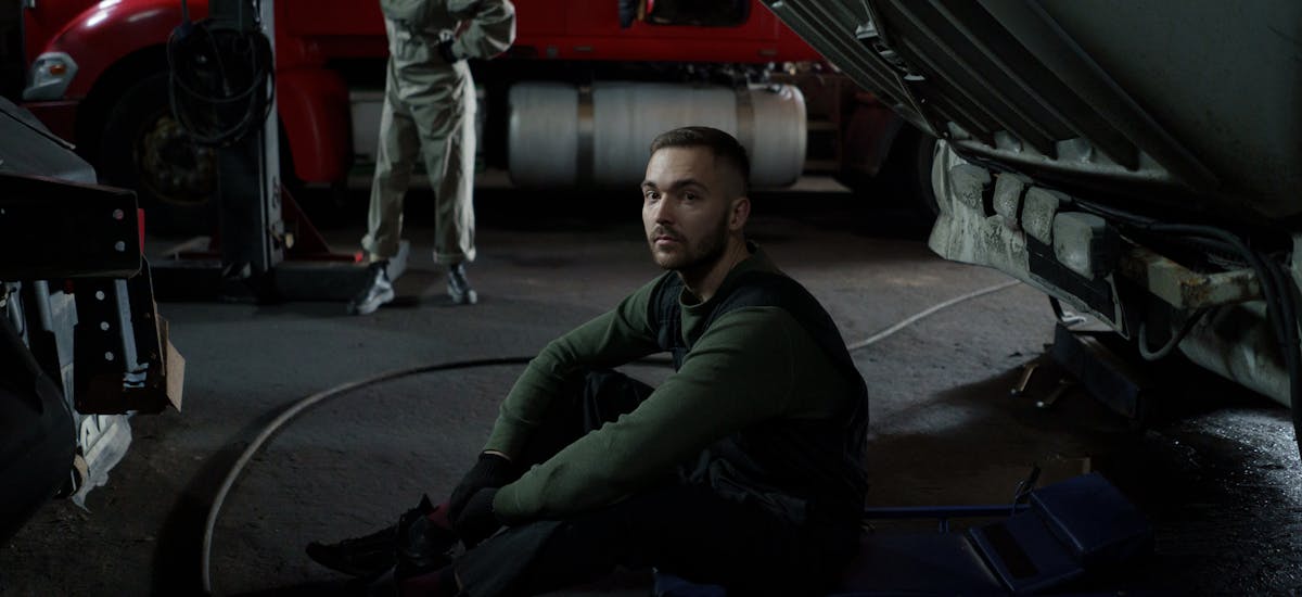 Mechanic inspecting engine components at HeVtech Tire Services.