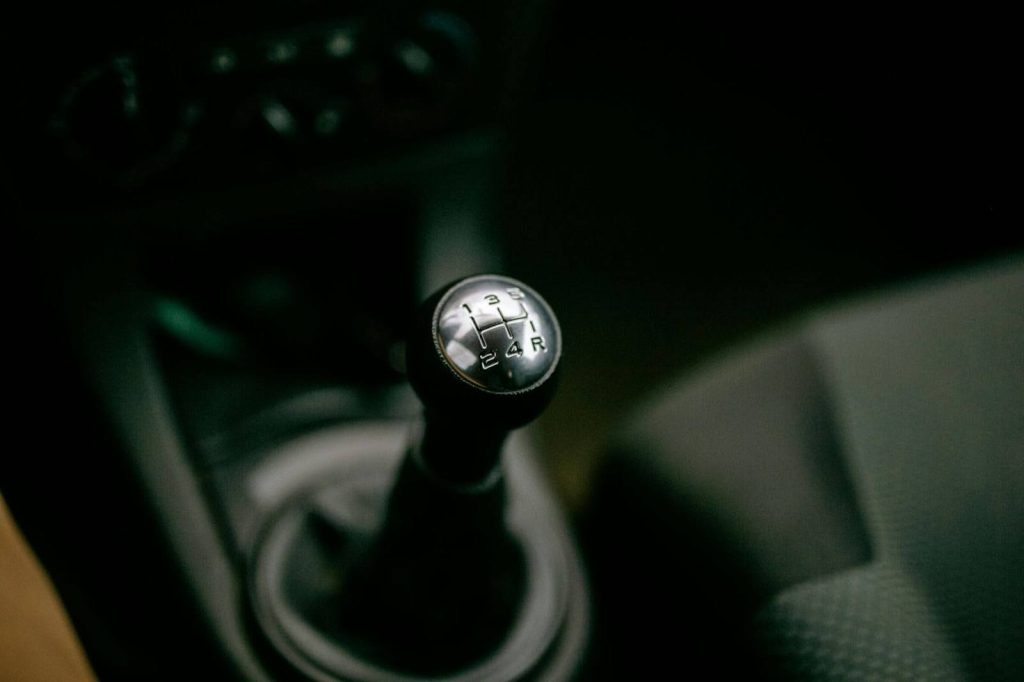 Manual transmission gear shift knob in a vehicle interior.