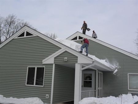 Men Shoveling On Roof
