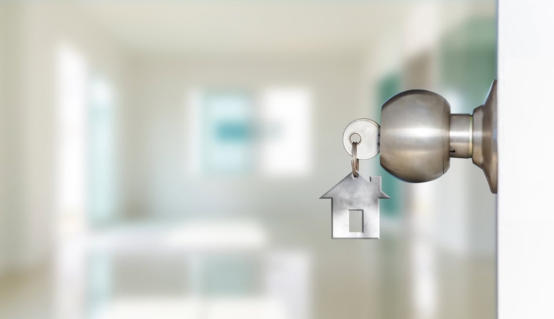 Open door with keys, key in keyhole