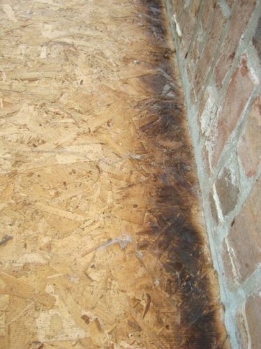 Scorched sheathing next to chimney
