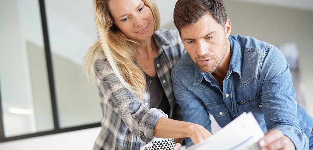 couple – looking at newspaper