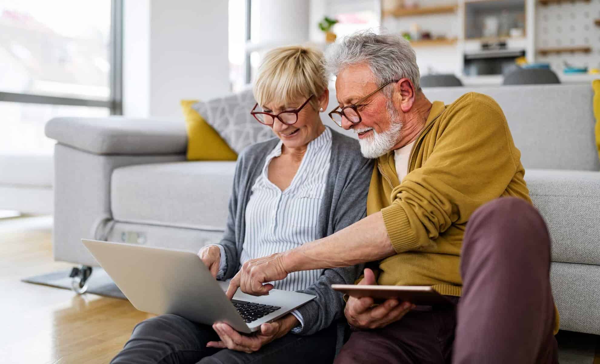 cheerful-senior-couple-using-technology