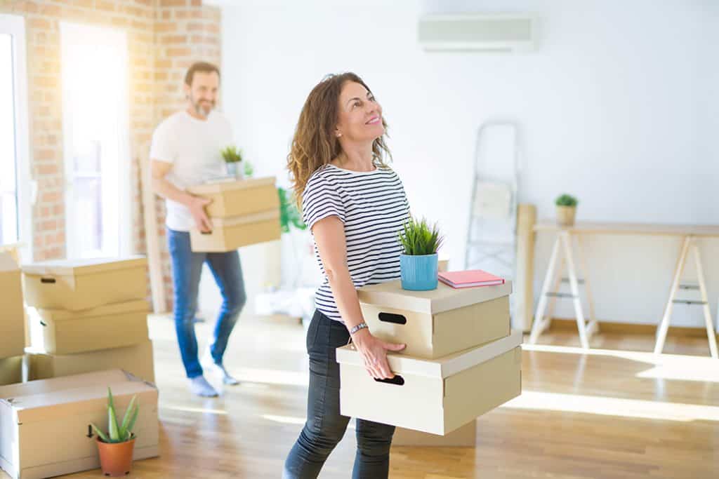 Middle Age Senior Couple Moving To A New House, Smiling Woman Ho