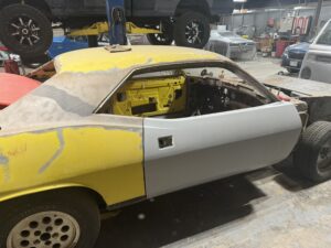 Automotive restoration of vintage car body and interior.