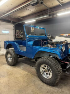 Blue vintage Jeep being restored at John's Auto Restorations.
