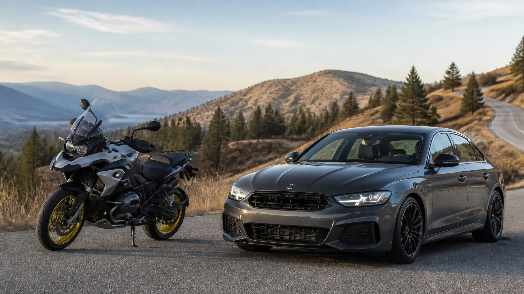 Car and motorcycle parked on mountain road with scenic landscape.