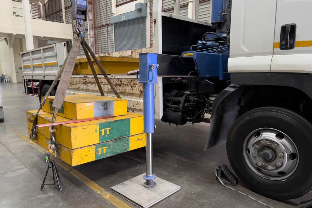 Image of a heavy-duty mechanical handling plant using a crane to lift 1-ton weights in an industrial warehouse setting. The equipment showcases the use of lifting mechanisms for safe, precise, and efficient material handling, highlighting the importance of proper operator training in ensuring both safety and productivity in mechanical handling tasks.