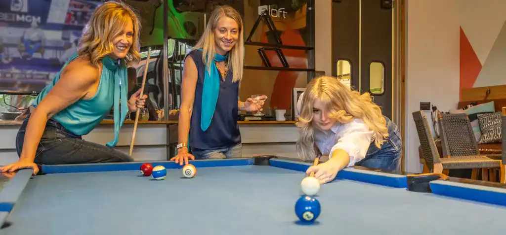 Enjoying a lively game of pool at Moxie360 Marketing event with colleagues and friends.