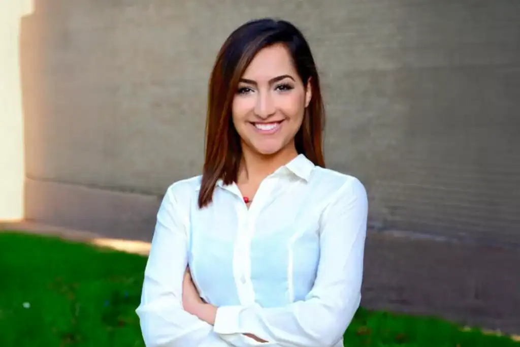 Confident businesswoman smiling outdoors, professional woman in white blouse, corporate leadership, marketing expertise, Moxie360 Marketing.
