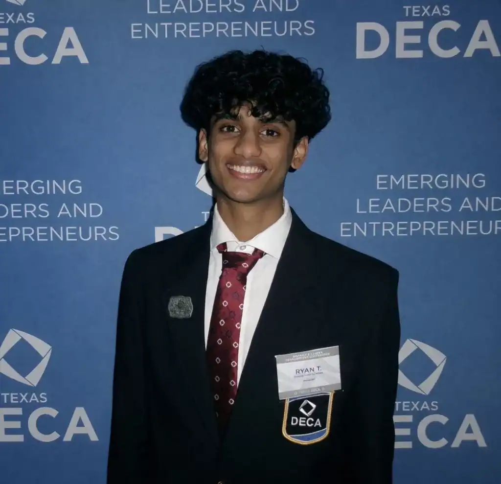 Young man in formal suit at Texas DECA conference.