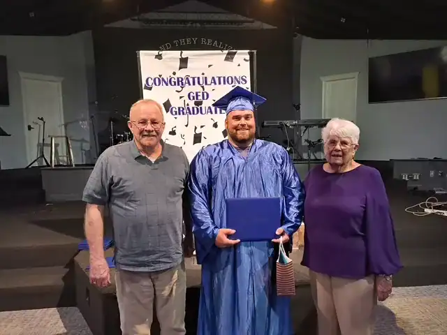 June Justin W. GED graduate with John and Diane Huthinson