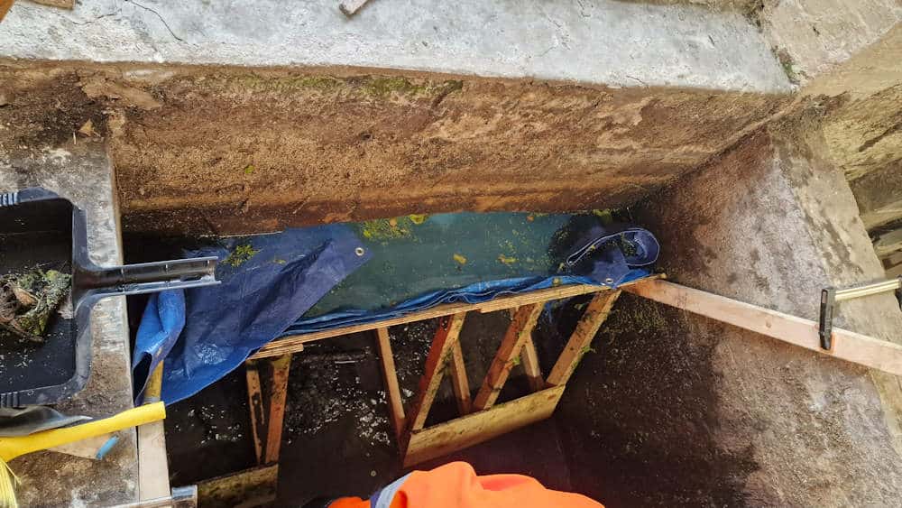 Before work started on the launder sluice a timber coffer dam had to be installed to hold the water back