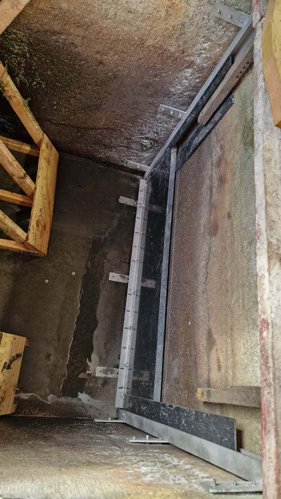 Fitting the new stainless-steel launder sluice frame inside the old concrete launder