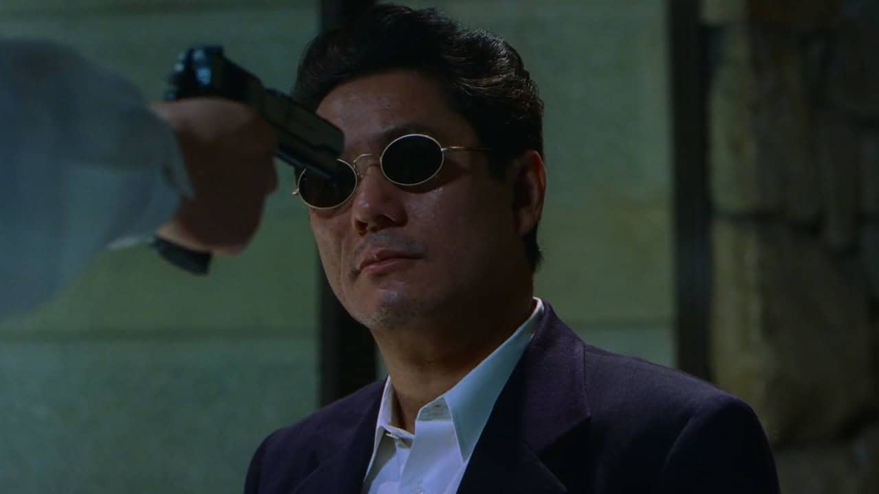 Takeshi Kitano in HANA-BI with a gun to his head