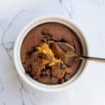 Rich, gooey chocolate chip cookie dough ice cream in a white bowl on a marble surface. Perfect for dessert lovers and those craving homemade, fresh ice cream treats.