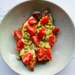 Roasted eggplant with cherry tomatoes, mozzarella, and green beans in a ceramic bowl, healthy vegetarian meal, fresh ingredients, easy recipe, colorful presentation, Simply Fresh Foodie.
