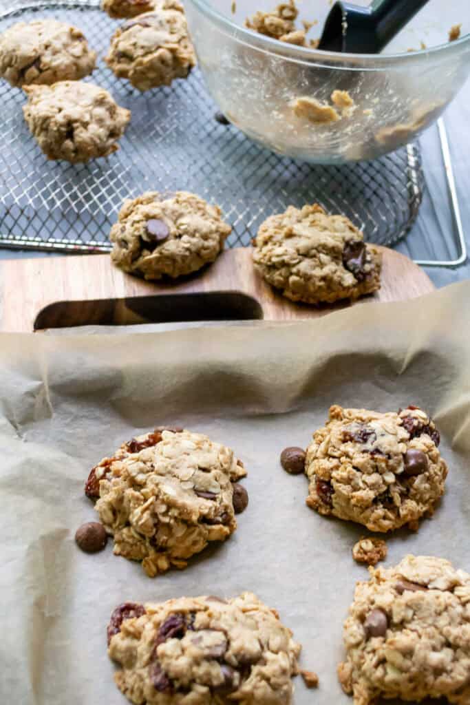 Buttery chocolate chip oatmeal cookie dough on parchment paper, freshly baked cookies with chocolate chips, healthy and delicious cookie recipes, simply fresh foodie baked goods, easy homemade oatmeal cookies.