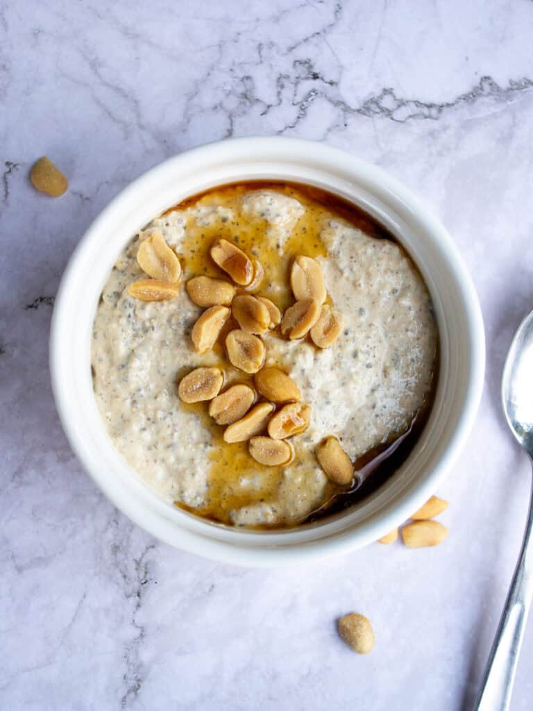 Top view of blended overnight oats with peanuts on top.