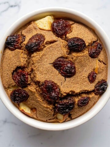 Creamy vegan ice cream topped with dried cranberries, served in a white bowl. Perfect for gluten-free, dairy-free, and plant-based dessert lovers seeking delicious, healthy treats.