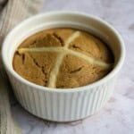 Gooey peanut butter cookie in a white ramekin, fresh baked, with a soft and chewy texture, perfect for snack or dessert, on a rustic marble surface.