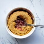 Savory cherry cobbler in a white ramekin with a spoon, homemade fruit dessert, simple fresh food, sweet and tart cherry filling, baked crust topping, delicious seasonal fruit dessert, easy dessert recipe, perfect for summer or fall, healthy fruit-based treat, comfort food dessert, family favorite dessert.