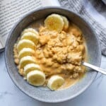 Creamy peanut butter banana oats with sliced bananas on top, served in a rustic bowl for a healthy and delicious breakfast. Perfect for a quick, nutritious morning meal.