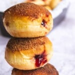 Warm homemade cherry-filled donuts with golden-brown crispy coating, drizzled with cherry jam, perfect for breakfast or dessert. Fresh, delicious, and easy to make at home.
