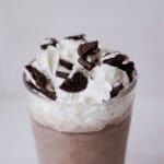 Rich chocolate milkshake topped with whipped cream and crushed Oreo cookies for a delicious treat.