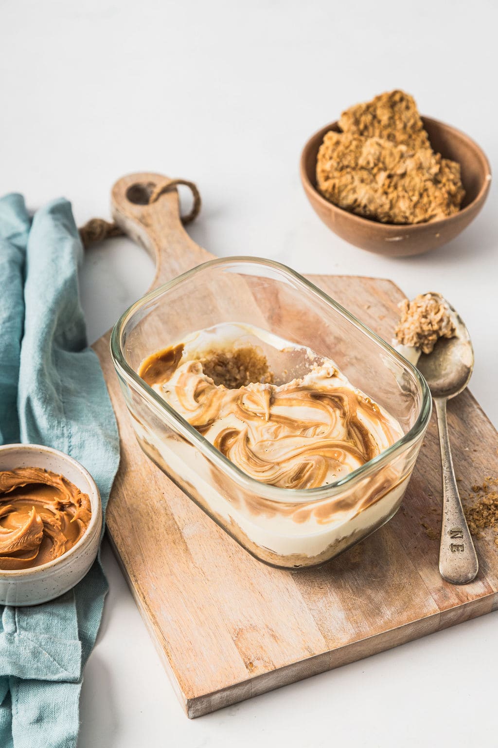 Angled front view of overnight weetabix with a Biscoff swirl in a glass meal prep container.
