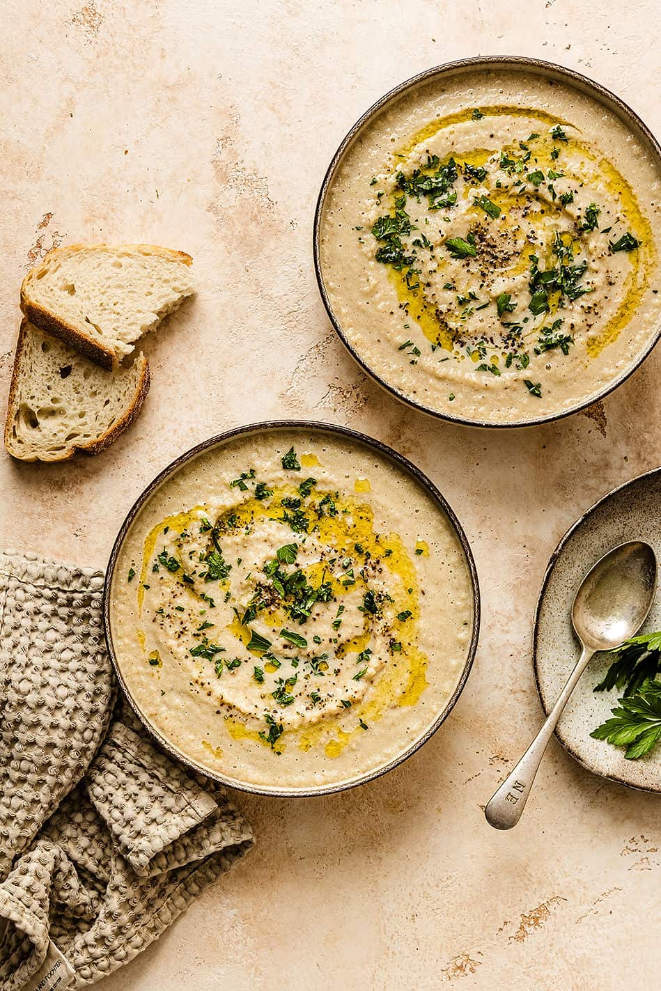 Overhead shot of two bowls of soup with bread.