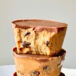 Rich chocolate chip cookie dough and brownie cups with smooth chocolate topping, perfect for dessert or snack, easy to prepare at home, ideal for chocolate lovers and sweet tooths.