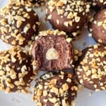 Rich chocolate truffles covered in chopped nuts, decadent homemade chocolate truffles with creamy filling topped with crunchy chopped nuts, perfect for dessert or gift, made with quality ingredients for a sweet treat.