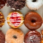 Vegan donut assortment featuring chocolate, strawberry, and classic glazed options, perfect for brunch in Chicago, with fresh, colorful toppings and delicious details.