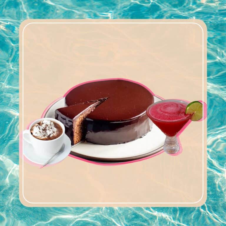 Rich chocolate cheesecake paired with a refreshing cranberry lime cocktail and a cup of hot cocoa with whipped cream, perfect for dessert or a sweet treat.