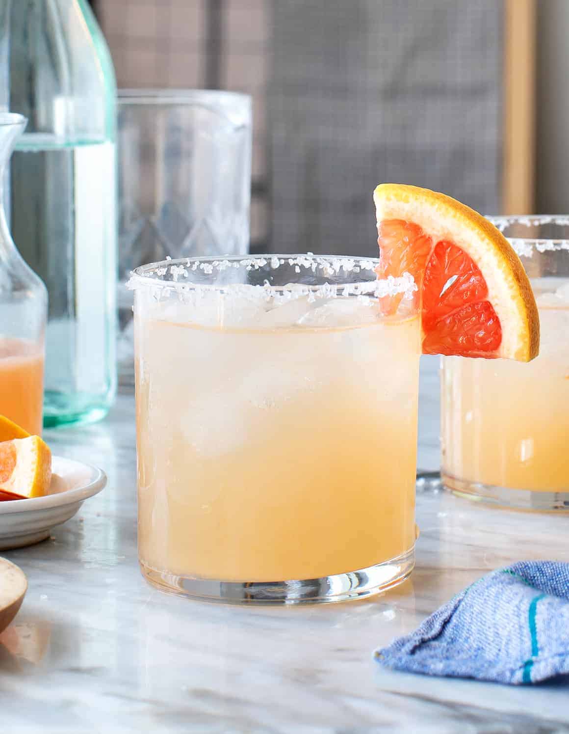 Paloma in a rocks glass, served with a salted rim and grapefruit wedge.