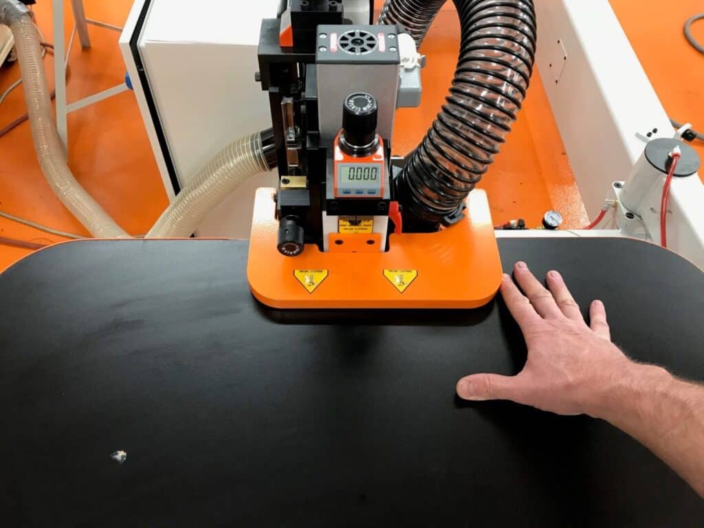 High-precision industrial cutting machine in action for manufacturing.